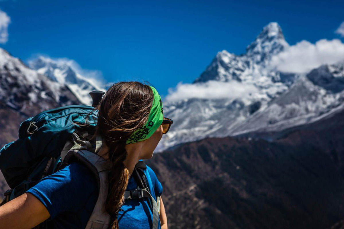 woman wearing headband overlooking mountains