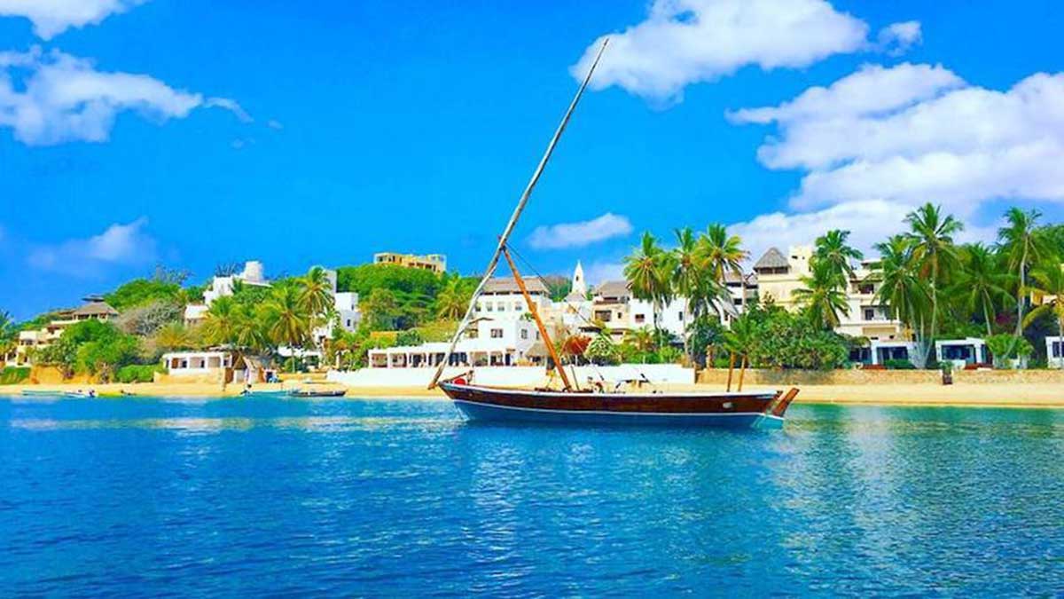 Sail boat floating on clear blue water