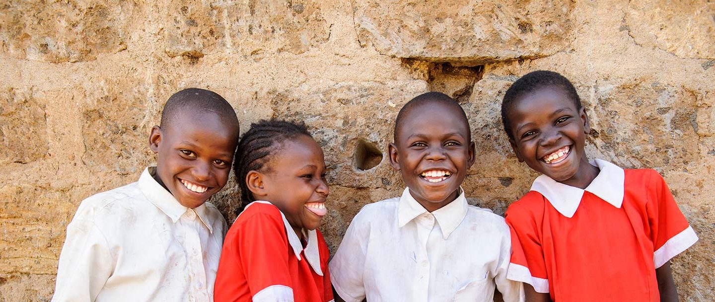 four young students smiling for photo