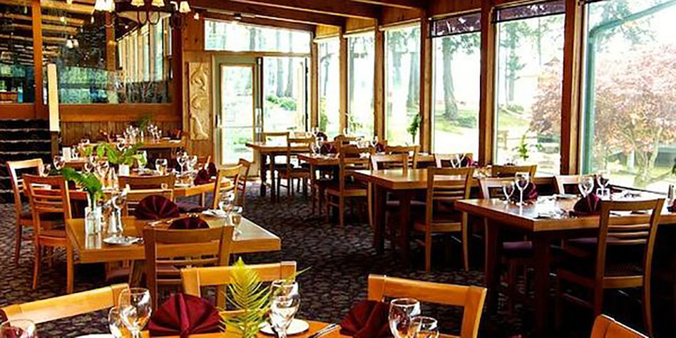 wooden tables set for dining in a conservatory type room