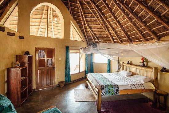 double bed in a thatched room