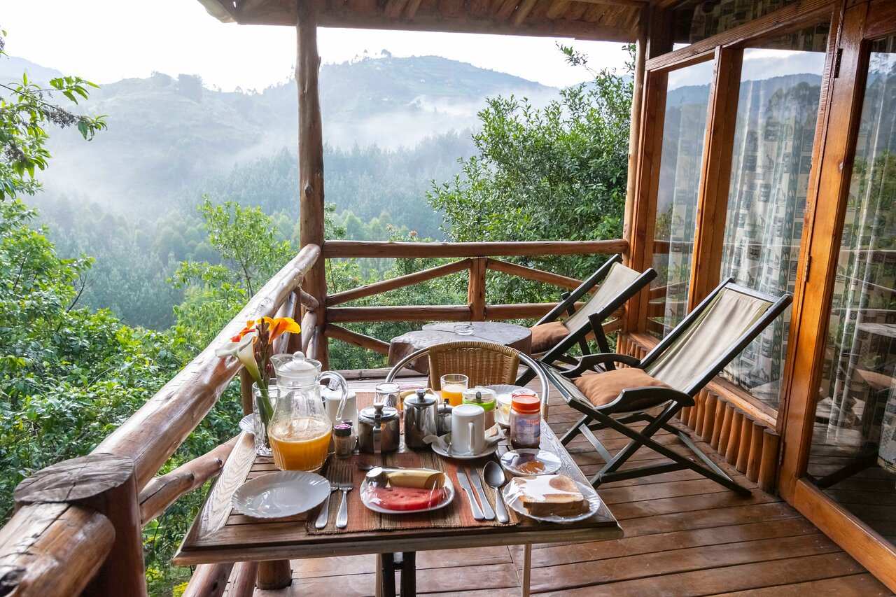 breakfast table on wooden balcony overlooking rain forest